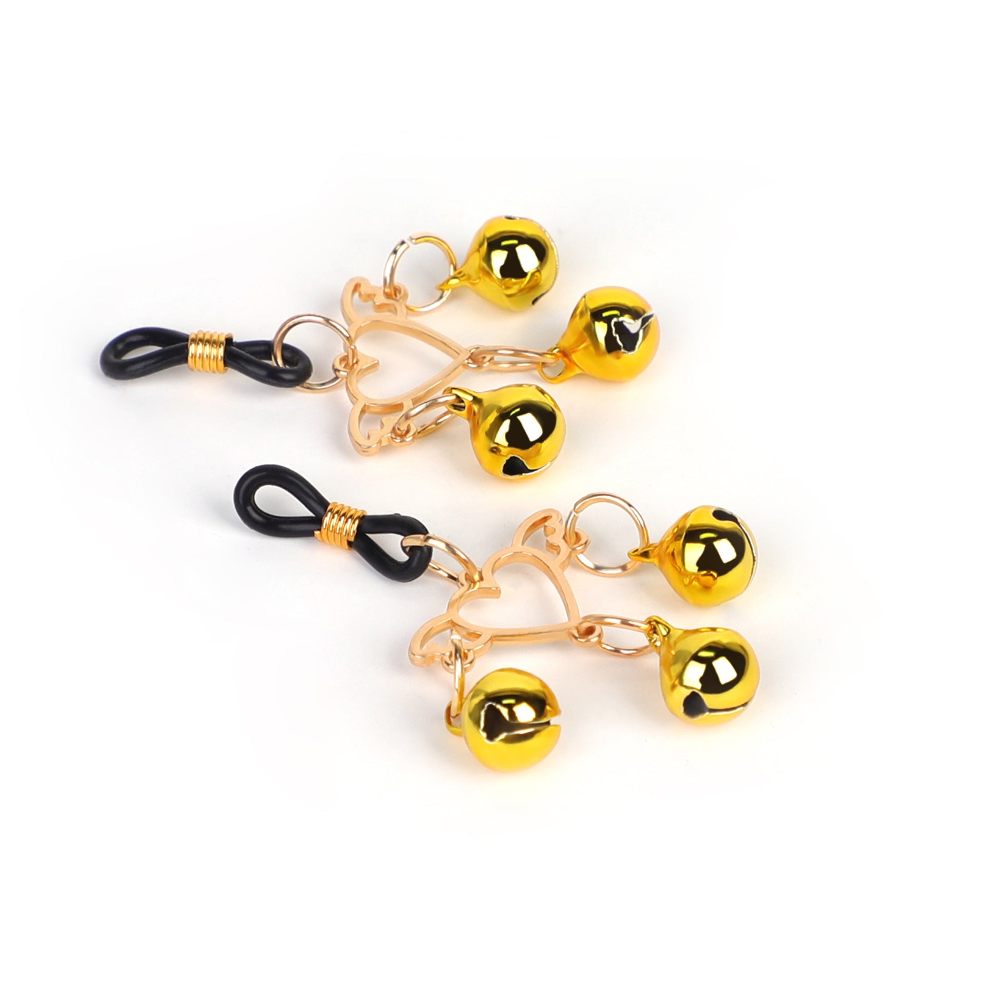 High-angle view of two gold nipple clamps with black adjustable rubber loops.