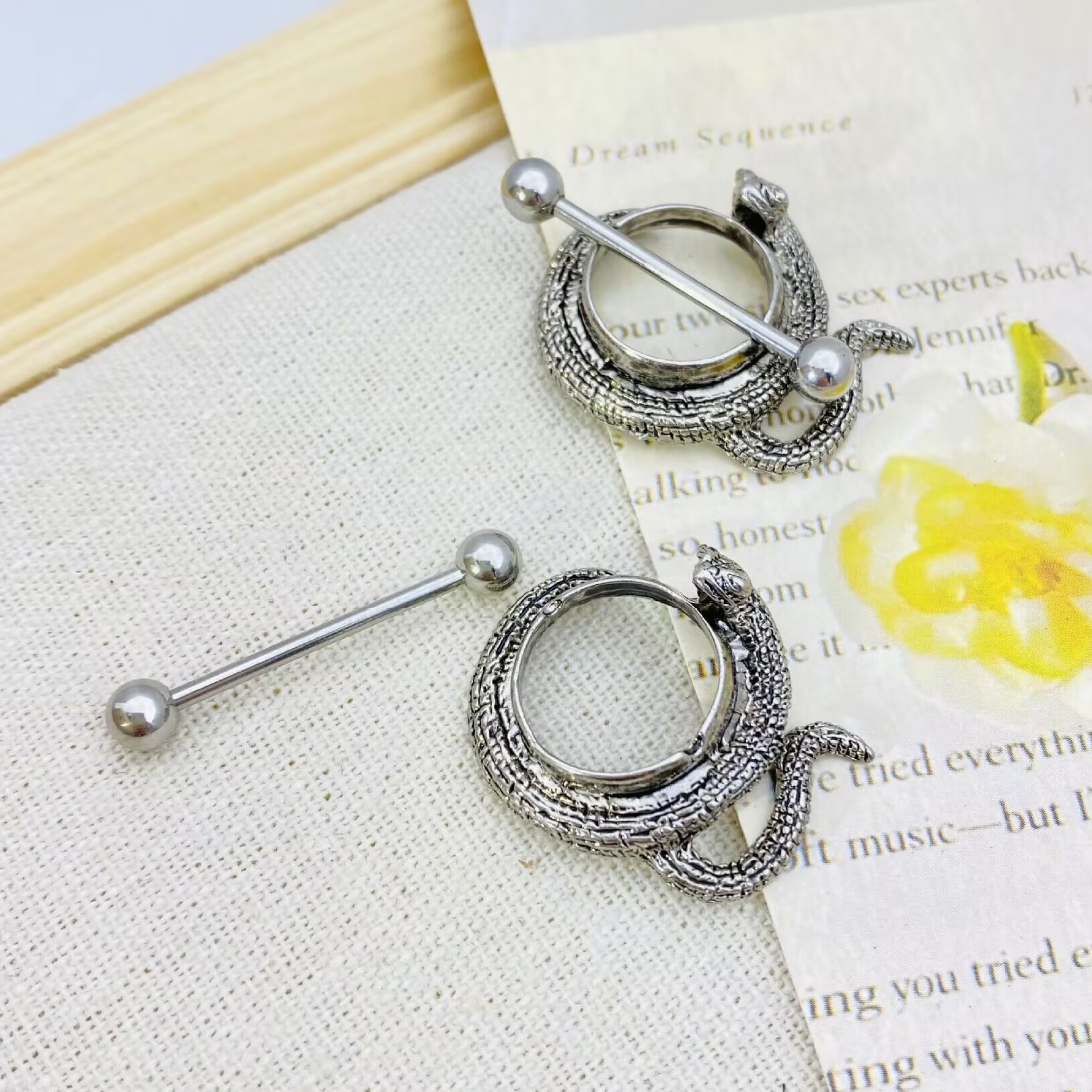 Two snake nipple shields placed on a vintage background, showcasing punk style.