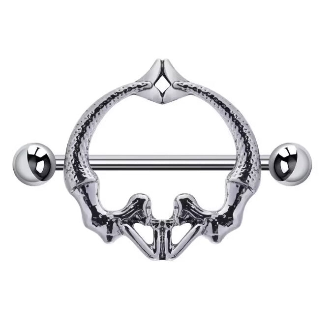 Front view of a gothic nipple shield shaped like a human pelvis or mirrored mermaids