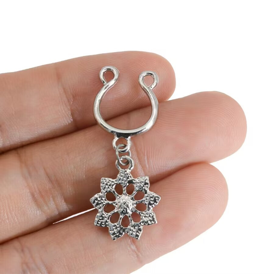 Close-up of the back of a floral non-piercing nipple shield held in hand to show the secure U-shaped clip and craftsmanship.