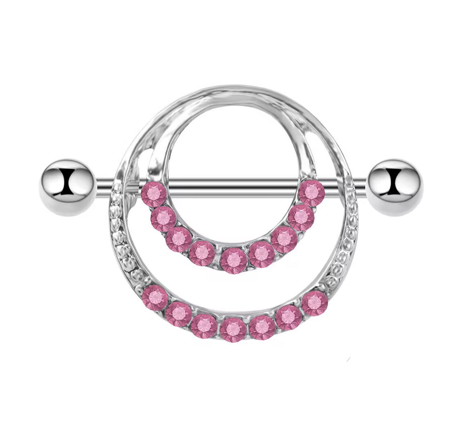 Close-up of a silver-tone nipple shield featuring double circular rows of pink crystals.