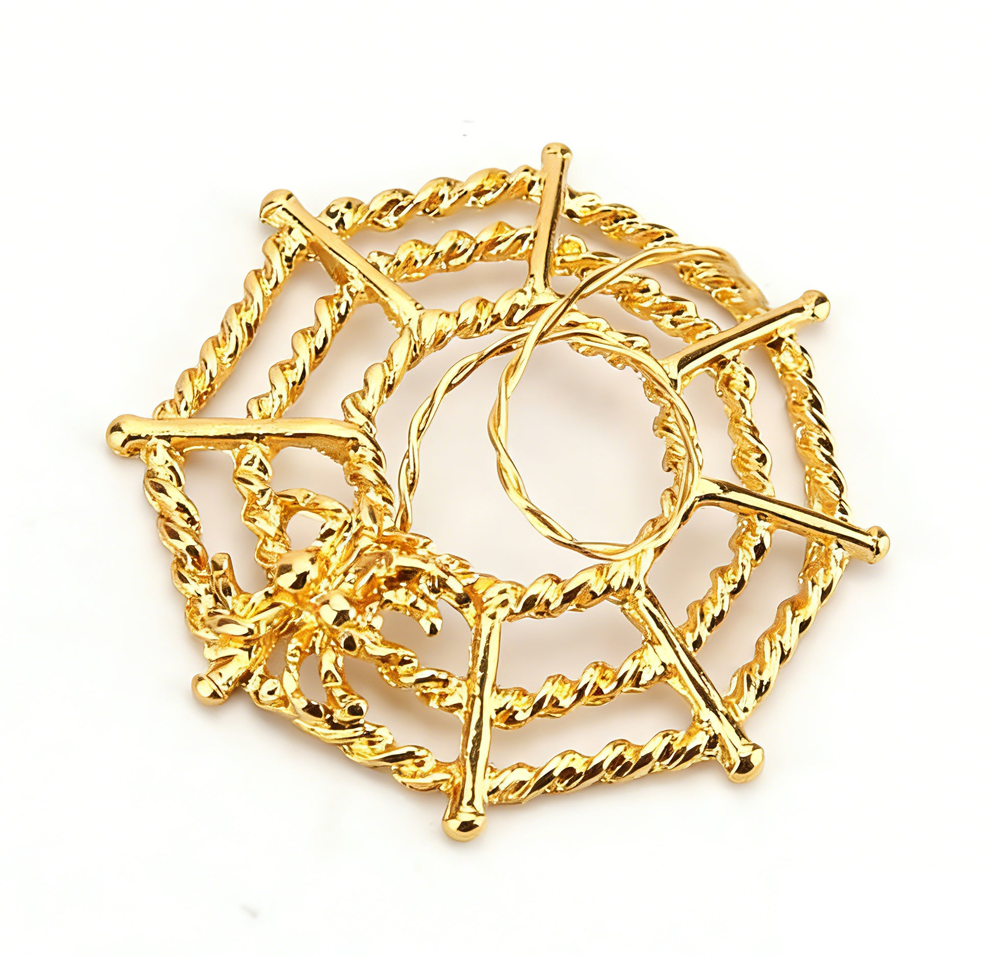 Golden alternative body jewelry featuring a web motif and spider.