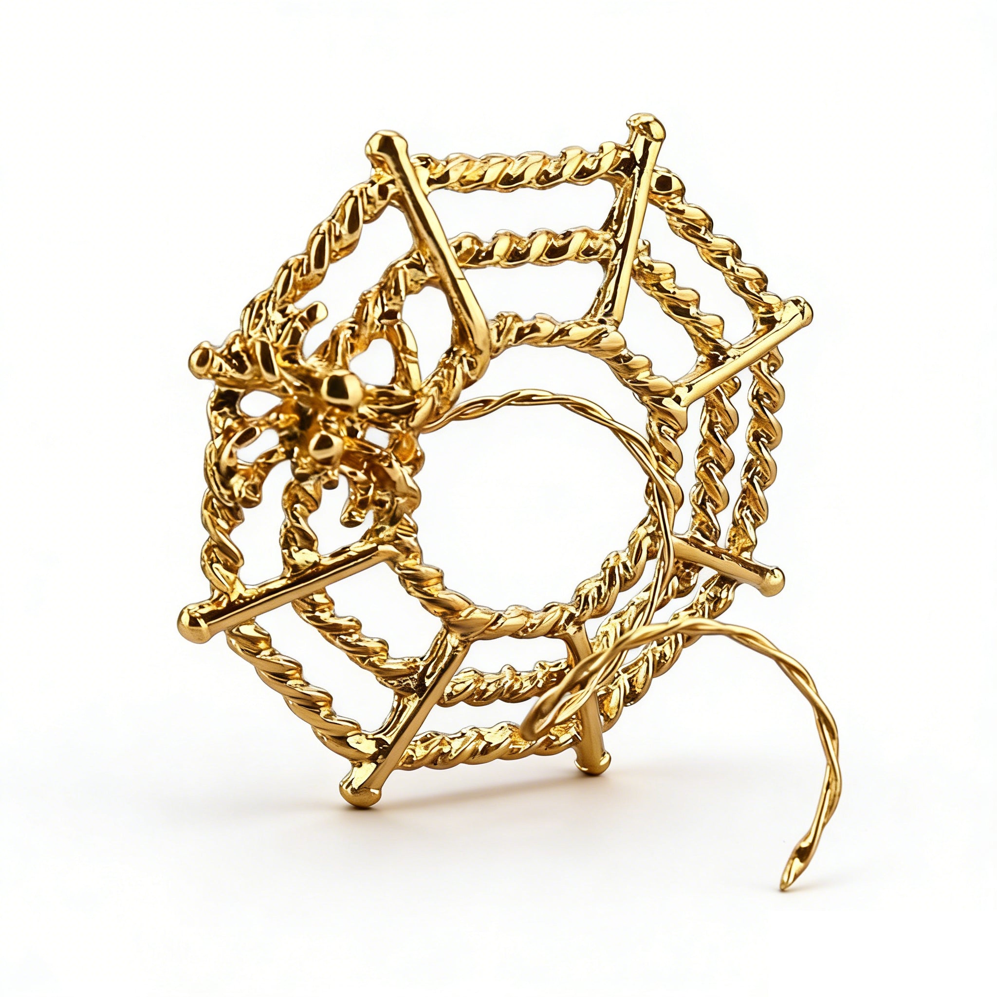 Gold-toned spider web nipple jewelry showing intricate spider detail.