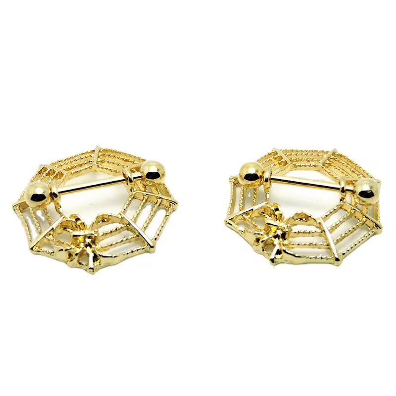 A pair of gold-toned spider web nipple jewelry for alternative fashion styling