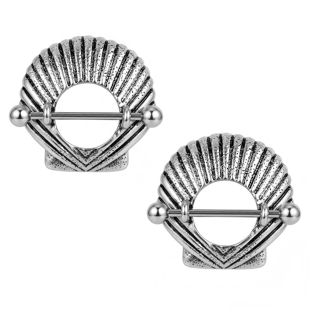 A matching pair of antique silver ocean-themed shell nipple shields.