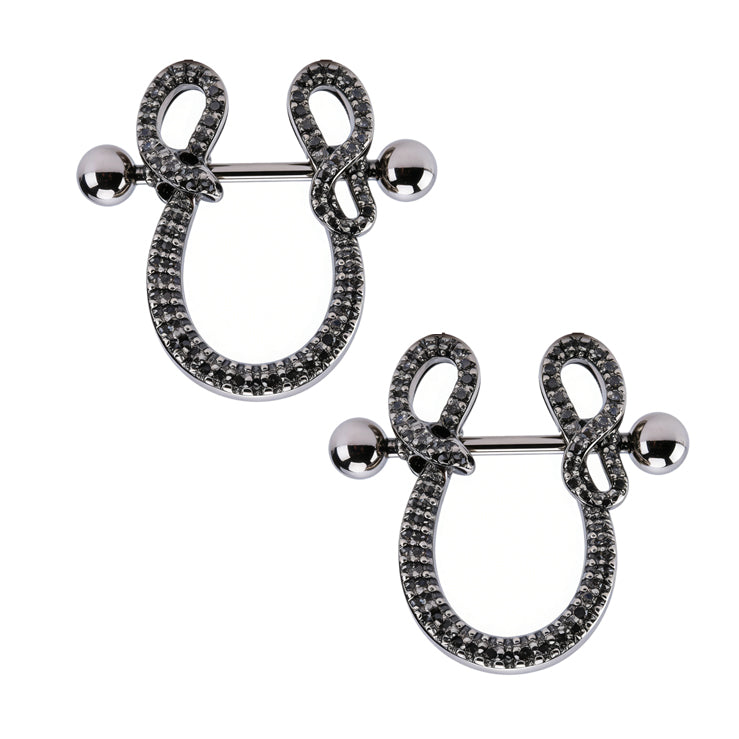 A matching pair of dark aesthetic snake nipple shields on a white background