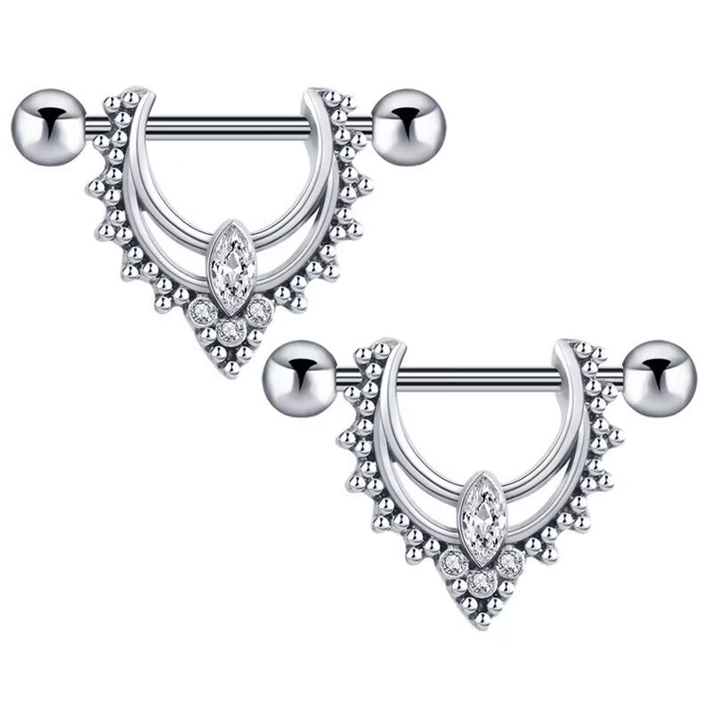 A pair of vintage-style nipple shield rings with sparkling gemstones for body piercing collectors.