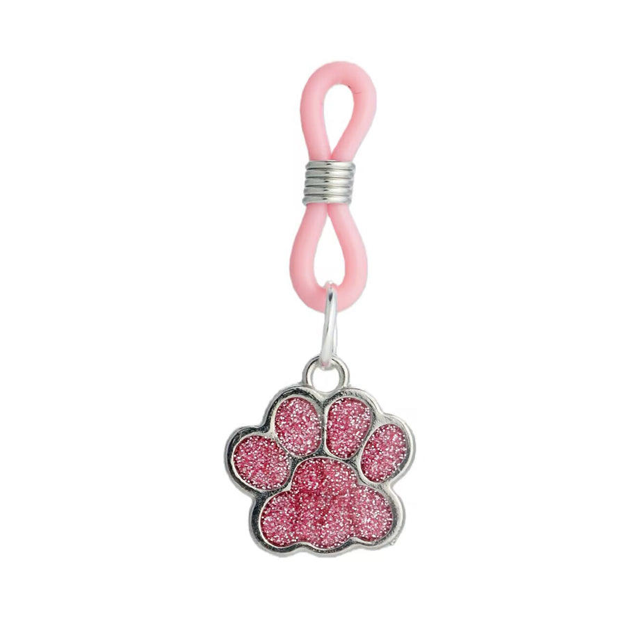 Close-up of a sparkling pink paw charm on an adjustable non-pierced body accessory.