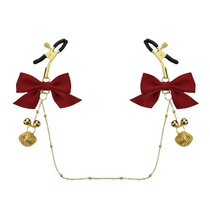 Adjustable sensory clamps with red bows and golden filigree bells.