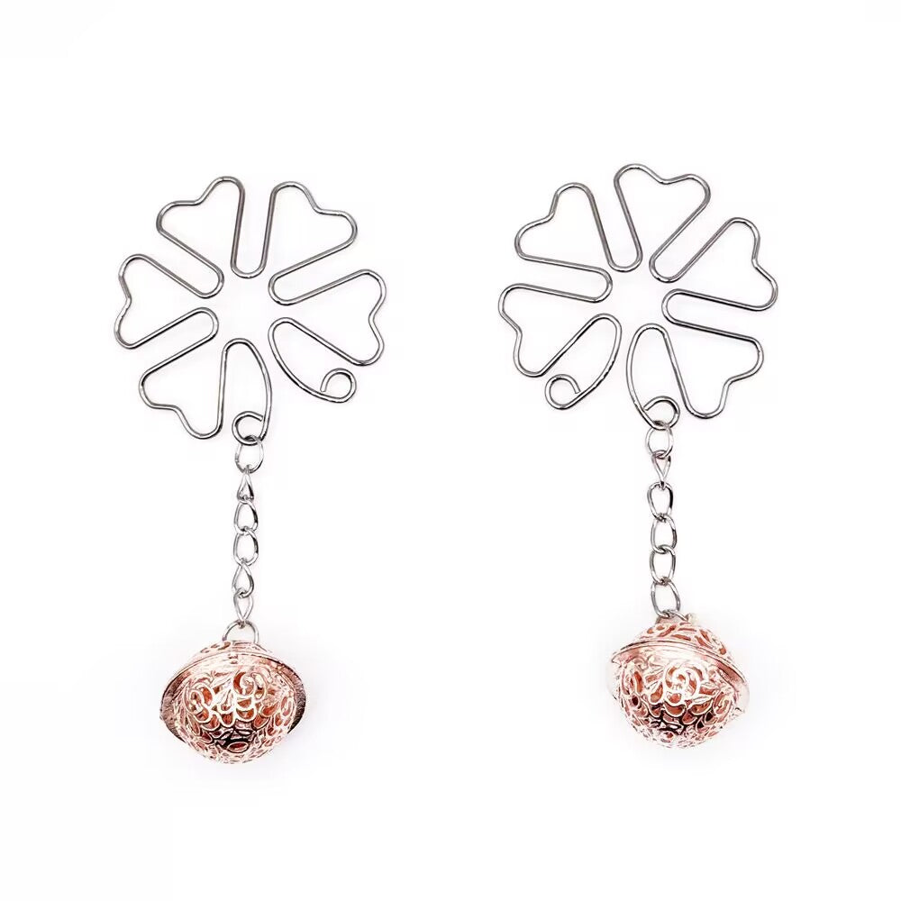 Front view of a pair of floral body clips with rose gold bell charms on a clean white background.