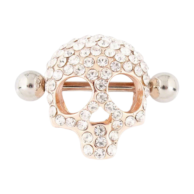 A front view of a rose-gold-toned skull nipple shield featuring shimmering crystal embellishments.