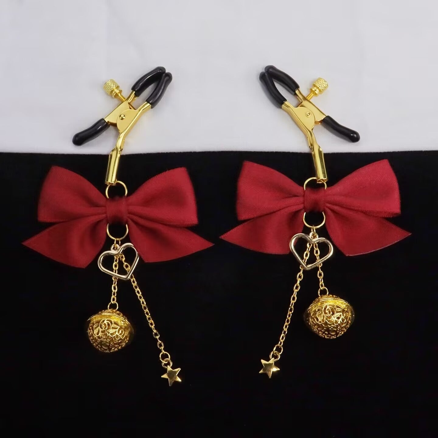 Professional flatlay of red bow clamps against a black and white background.