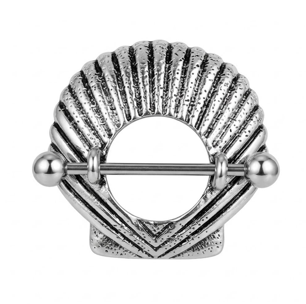 Front view of a vintage silver scallop shell nipple shield piercing.