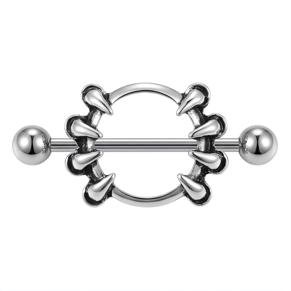 Front view of a vintage silver-tone nipple shield with eight pointed claw accents.